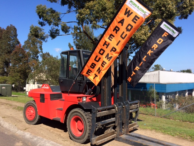 forklifts with banner of warehouse equipment sale and hire